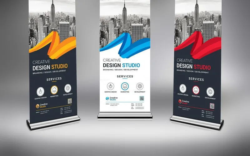 Three roll-up standee displays